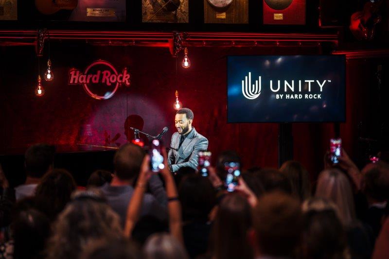 Hard Rock International hosted an exclusive event, “Unity by Hard Rock Come Together for Good,” featuring a private performance by John Legend at the original Hard Rock Cafe in London. This event was part of the ongoing celebration of the Unity by Hard Rock™ global loyalty program launch. In recognition of Legend's philanthropic efforts, Hard Rock presented a $100,000 donation to The Show Me Campaign, an organization dedicated to transforming educational opportunities for young people. This initiative, a fiscally sponsored program of the Social Impact Fund, aims to ensure that all students have the chance to pursue their dreams through impactful education. The intimate concert featured Legend performing beloved hits such as "Ordinary People," "Tonight," and "All of Me" for a select audience of Unity members and special guests. Among the attendees were two lucky Unity members from Yukon, Oklahoma, who won the Come Together Experiences sweepstakes. They enjoyed exclusive merchandise, a $200 Rock Shop gift card, and an overnight stay in the inaugural 'Hard Rock House,' a local residence adorned with Hard Rock’s signature music-inspired decor. John Legend’s relationship with Hard Rock dates back years, including performances at Hard Rock Live venues and the grand opening of Hard Rock Hotel New York. He recently participated in the Unity global loyalty program launch campaign, which featured other stars such as Lionel Messi, Shakira, and Noah Kahan covering The Beatles. Unity by Hard Rock integrates casino, hotel, restaurant, retail, and entertainment loyalty programs into one global platform, offering members the chance to earn points for hotel stays, dining experiences, and merchandise, alongside exclusive offers and rewards.